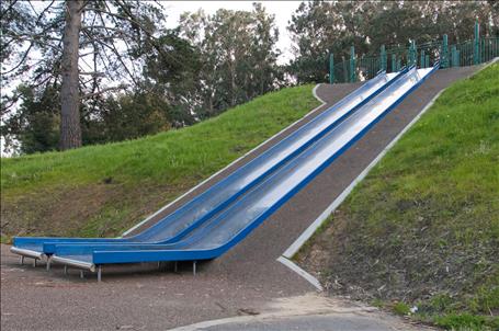 A pair of 1643-241-EMB Wide Embankment Stainless Steel Slide Chutes